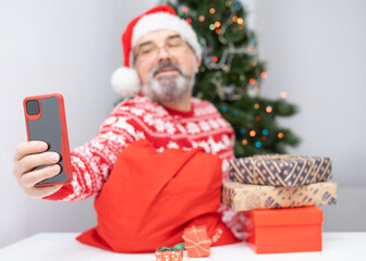 Portrait of a man with a beard and Santa hat
