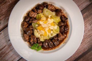 Recipe of sweetbread and lamb kidney with cocoa, leek whistles with almonds and oranges. High quality photo