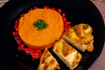 Chicken supreme recipe, gently cooked with 5 spices, sweet potato mousseline, peppers cut in half. High quality photo