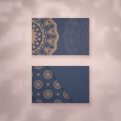 Presentable business card in blue with a mandala in brown pattern for your brand.