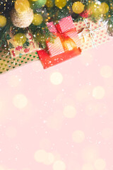 top view of christmas presents under a christmas tree with bokeh lights