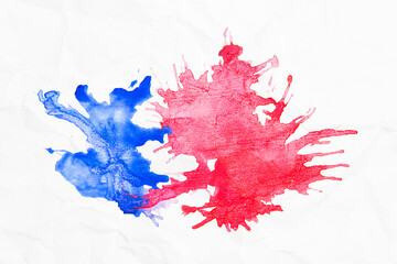 Abstract blue and red splash watercolor, drawn by blowing air on wrinkled white paper.Splash watercolor background.