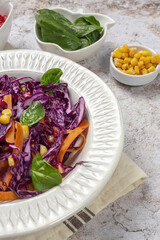 Homemade Purple Cabbage Salad with Corn, Carrots, Pomegranate and Spinach