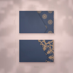 Presentable business card in blue with luxurious brown ornaments for your personality.