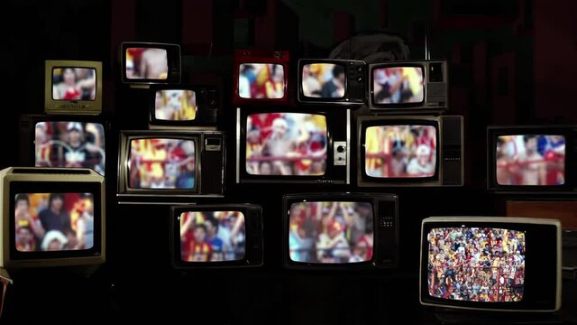 Blurred Soccer Fans in a Stadium on a Stack of Retro TVs. 4K Resolution.