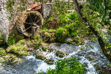 The rusty wheel of an old watermill