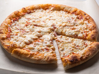 Appetizing pizza, cut into pieces. Italian food, natural ingredients