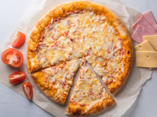 Appetizing pizza, cut into pieces. Italian food, natural ingredients