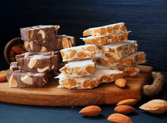Chocolate and sugar Spanish turron with almonds. Close-up