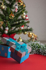 vertical christmas background with a christmas tree in the background and two gift boxes at the base