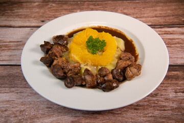 Recipe of sweetbread and lamb kidney with cocoa, leek whistles with almonds and oranges. High quality photo