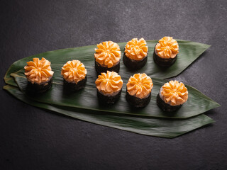 Maki Sushi Roll for Christmas on a green bamboo leaf.