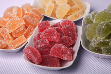 Dessert marmalade in the form of lemon and orange slices. The sweetness of jelly candy.