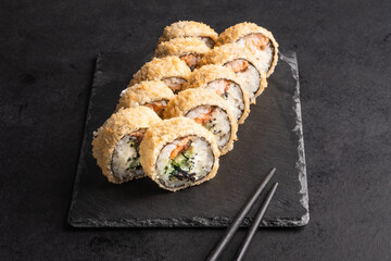 Japanese cuisine -Hot fried Sushi Roll with salmon, avocado and cheese. Sushi menu. 