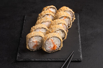 Japanese cuisine -Hot fried Sushi Roll with salmon, avocado and cheese. Sushi menu. 