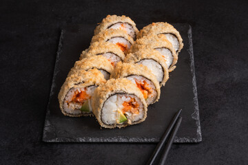 Japanese cuisine -Hot fried Sushi Roll with salmon, avocado and cheese. Sushi menu. 
