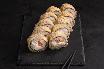 Japanese cuisine -Hot fried Sushi Roll with salmon, avocado and cheese. Sushi menu. 