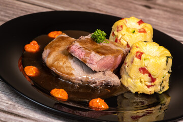 Recipe for roasted veal in butter, piquillo pesto, canele of polebta with crunchy vegetables, honey rosemary sauce. High quality photo