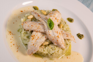 Baked sole fillet, risotto and pesto recipe. High quality photo