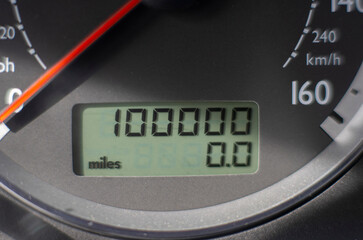 A car odometer with 100,000 miles 