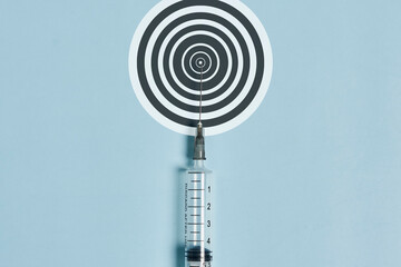 Syringe and aim on blue. High quality photo.
