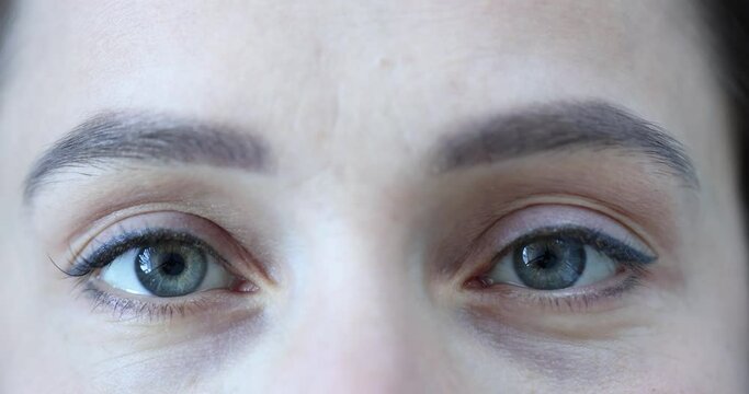 Female eyes with a gray green pupil slow motion 4k movie