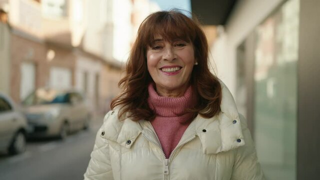 Middle age redhead woman smiling confident standing at street
