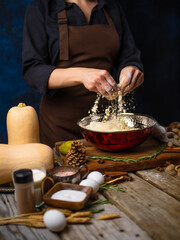 The chef prepares the dough. Levitation. Ingredients for making a traditional American Pumpkin Pie. Decor. Wood texture. Close-up. Restaurant, hotel, bakery, pastry shop.