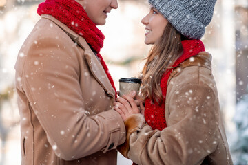 Closeup of romantic lovers drinking coffee at winter park