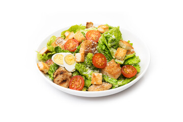 Caesar salad with chicken, croutons and parmesan in a plate isolated on a white background