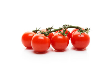 Red cherry tomatoes on a branch isolated on a white background