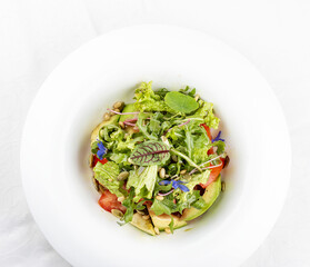 Salad with avocado and pine nuts. Isolated on a white background.