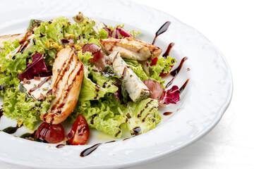 Salad with chicken fillet, dor blue cheese and pistachios. Isolated on a white background.