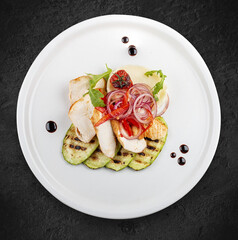 Baked chicken fillet on a pillow of mashed potatoes. Isolated on a white background.