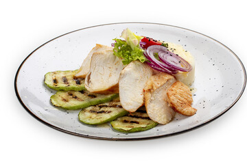 Baked chicken fillet on a pillow of mashed potatoes. Isolated on a white background.
