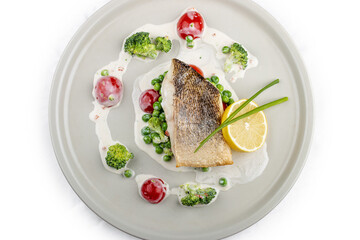 Pike perch on a vegetable pillow . Isolated on a white background.