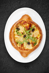 Traditional Georgian cuisine. Adjarian khachapuri. Isolated on a black background.