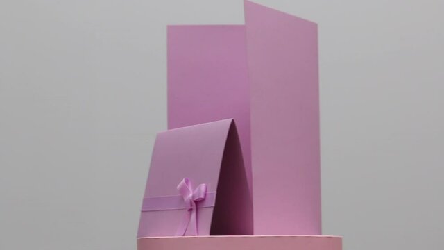 Making greeting cards. Paper blanks, ribbons and lagurus branches. Stands on a rotating stage. On white background_