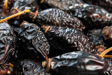 Dry rose hips. Dried wrinkled briar berries. Dog-rose fruits. Macro