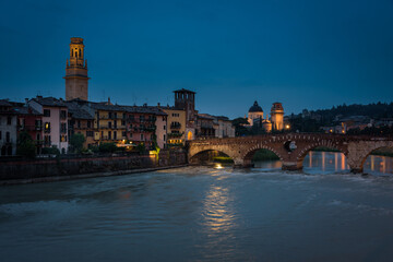Buildings of the old town along the bank of the Adige river and the famous Stone Bridge (Ponte di...