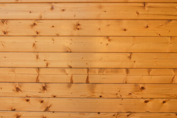 Wooden background. Horizontal planks with knots knocked together. Backdrop of yellow wooden boards. Overall plan.