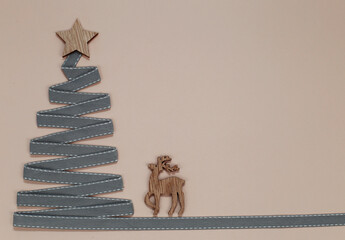 Christmas tree made from ribbon with a star. Place for your text.
