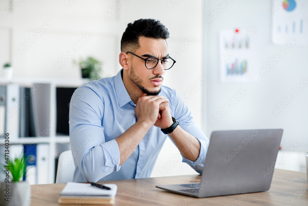 Aufkleber stressed arab man using laptop, having problem performing work task, making mistake in business proj