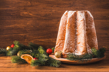Pandoro Italian Christmas sweet bread on wooden background copy space.
