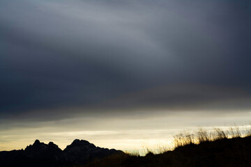 sunset on the lake's shore on dolomites