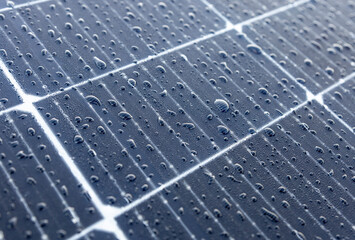 Solar panels on a construction site with raindrops on them