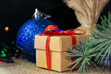 Christmas holidays composition with gift boxes, toys and coniferous tree branch. Happy New Year and Merry Christmas concept