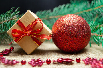 Christmas holidays composition with gift boxes, toys and coniferous tree branch. Happy New Year and Merry Christmas concept