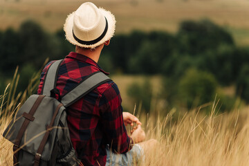 Hiker with a backpack enjoying the view of the valley, the tourist walks along the valley. Travel and adventure concept