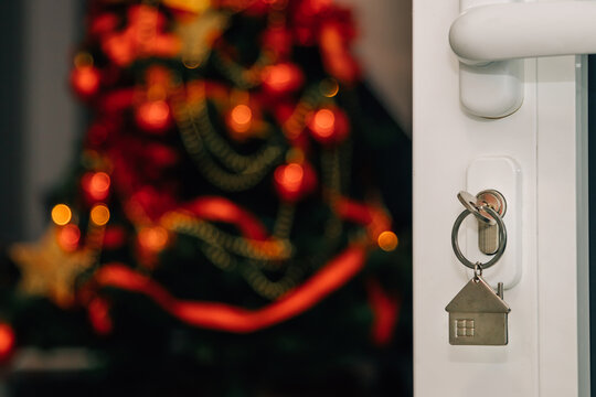 Keys In Open Door Lock With Christmas Tree Inside House